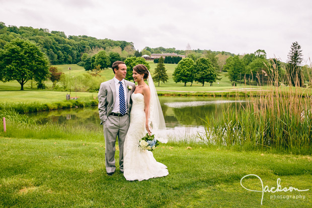 bride and groom by water golf course