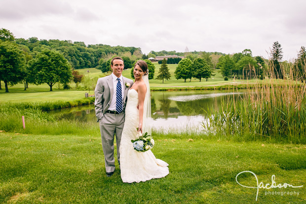 bride and groom by water golf course